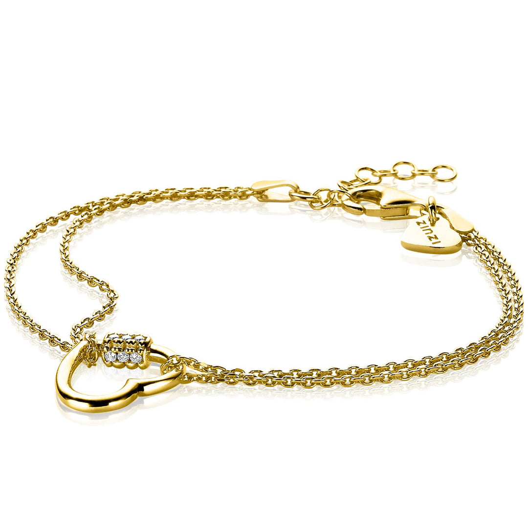 De Zinzi Armband Gold Plated Zia2031 is een gouden armband met een ingewikkelde ketting van in elkaar verstrengelde hartlussen, met één lus versierd met witte zirkonias. Een klein LOVE-hartlabel hangt bij de sluiting, wat charme toevoegt aan dit prachtig vergulde Zinzi-ontwerp.