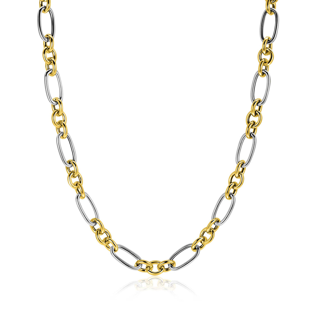 De Zinzi ketting ZIC2667 45cm van Zinzi heeft afwisselend gouden en zilveren ovale schakels in een stijlvol kettingpatroon, elegant weergegeven op een witte achtergrond.