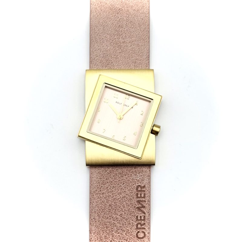 Orologio Rolf Cremer con cassa quadrata dorata e cinturino in pelle rosa.