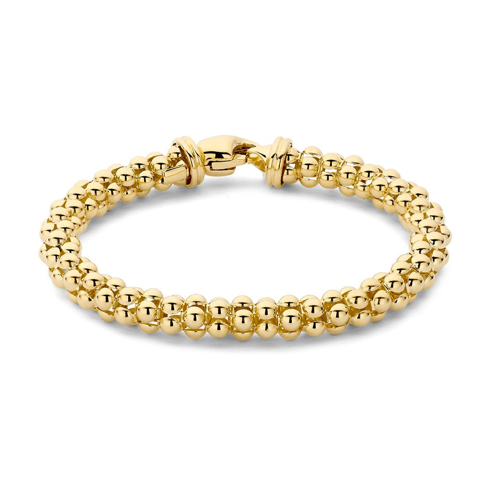 Bracciale in oro giallo con perline rotonde e chiusura a moschettone.
