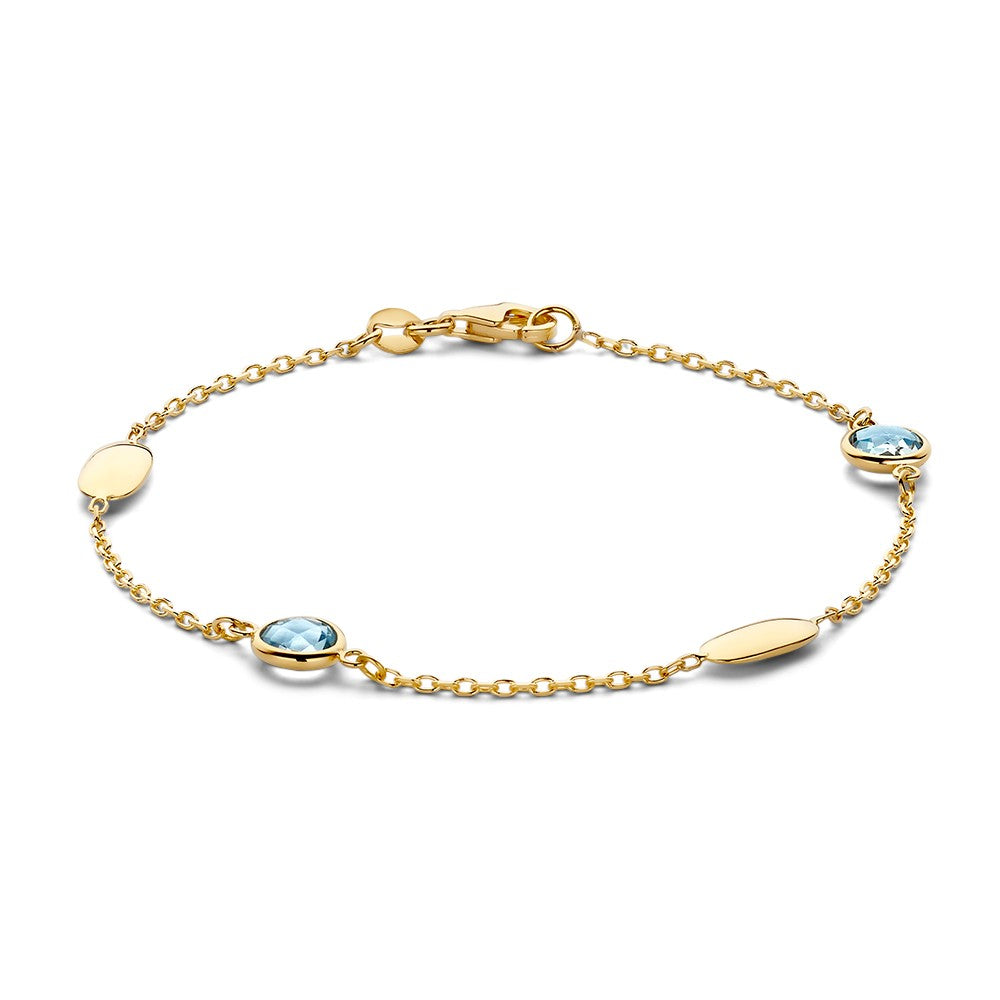Bracciale in oro giallo con pietre preziose blu e dettagli ovali.