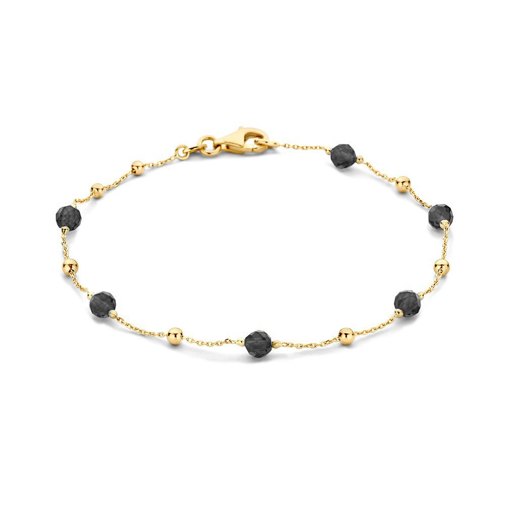 Bracciale in oro giallo con zircone e sfere nere.