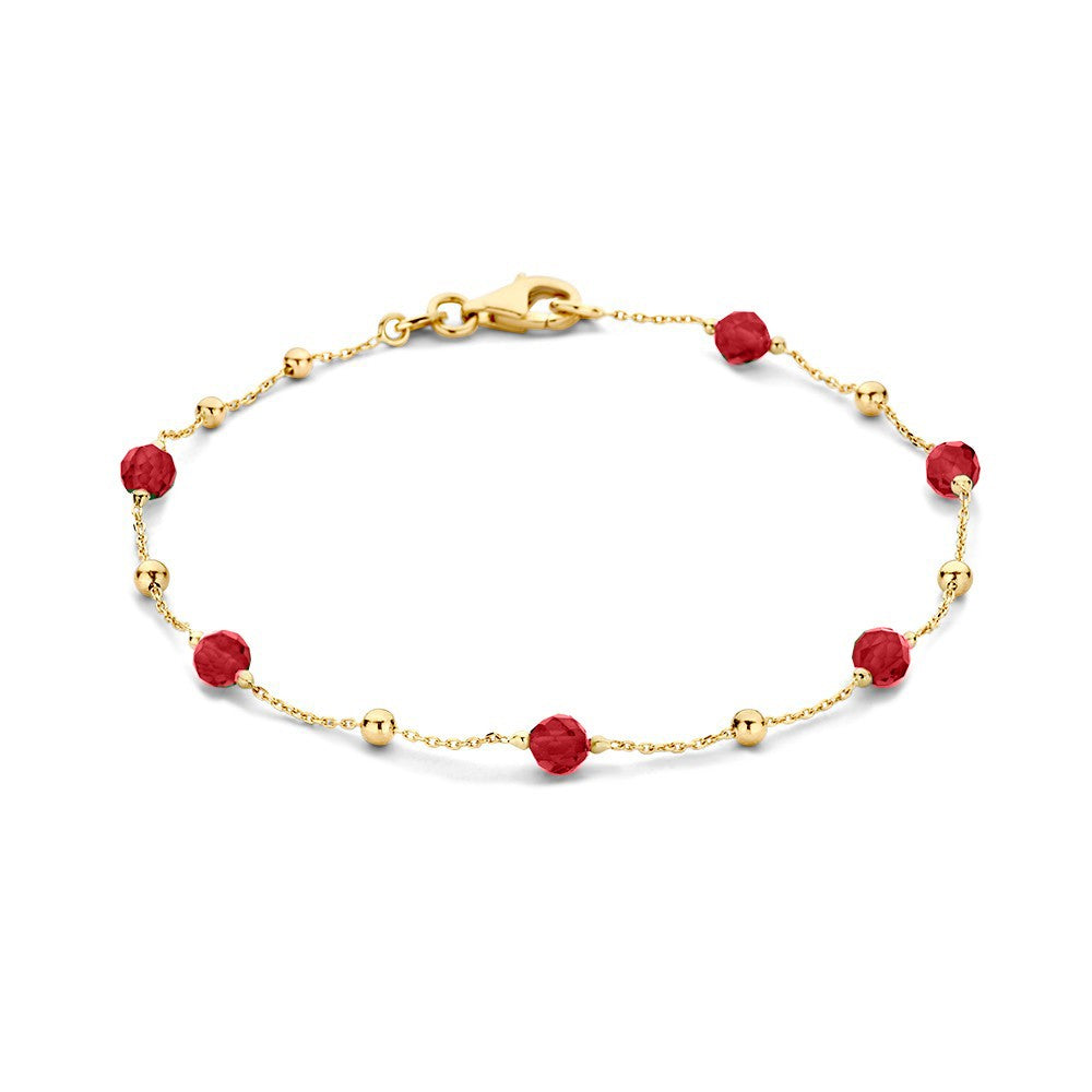 Bracciale in oro giallo con zirconi e perle rosse.