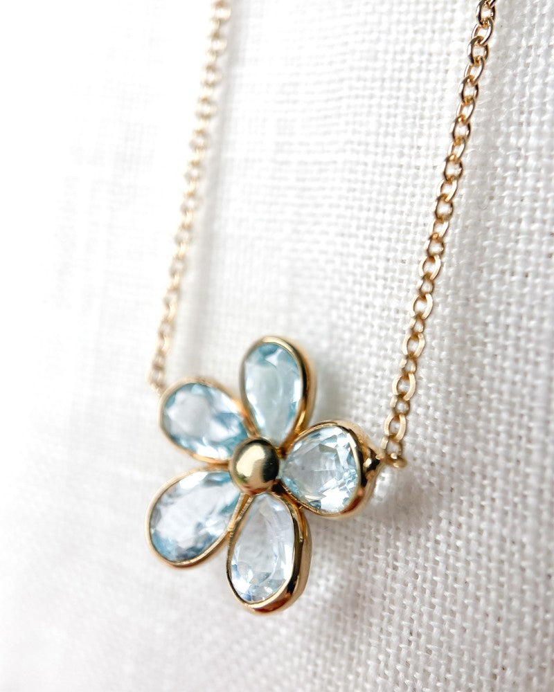 Collana in oro giallo con ciondolo a fiore giocoso e topazio blu – oro 14 carati