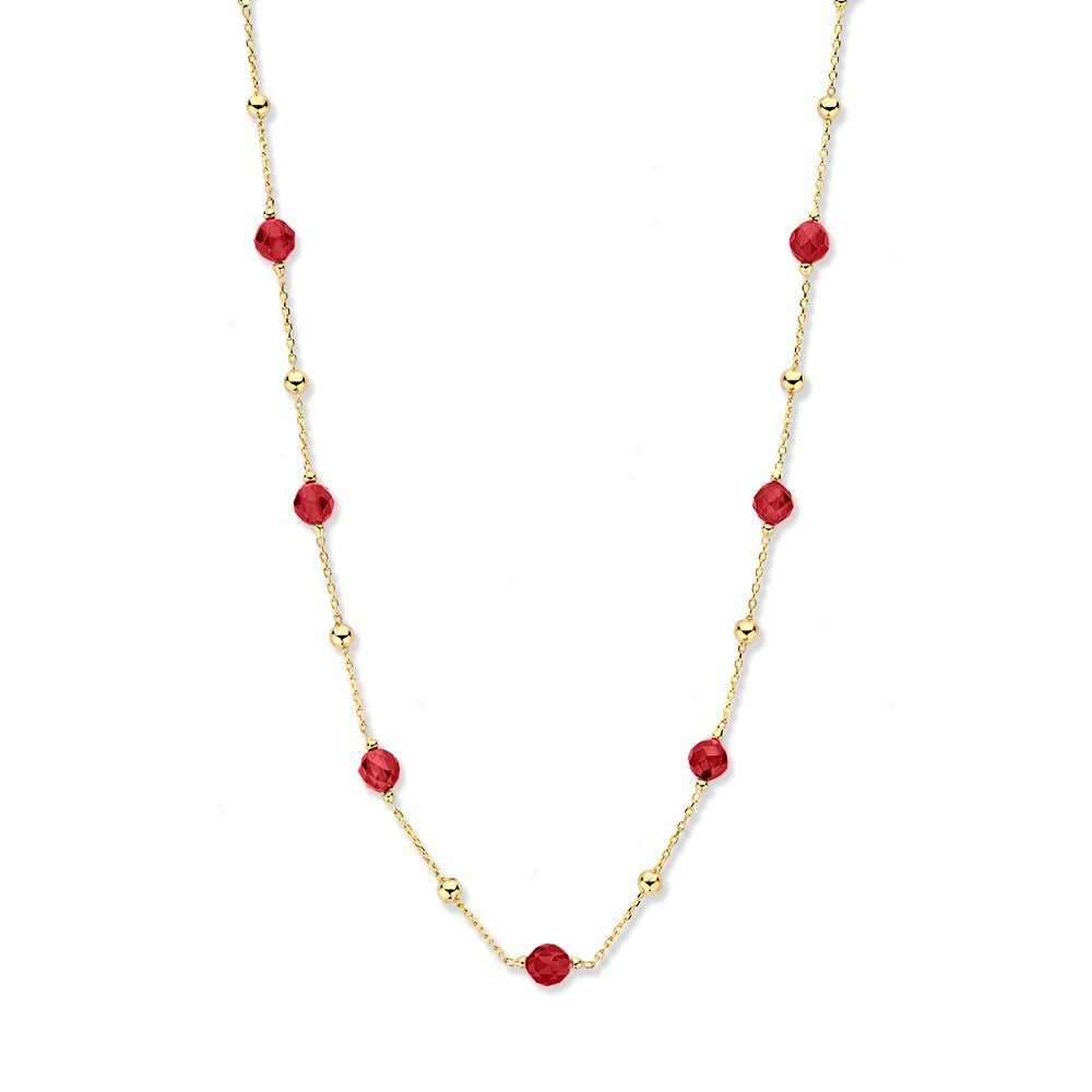 Collier van geelgoud met zirkonia en rode kristallen, afgewerkt met kleine gouden bolletjes.