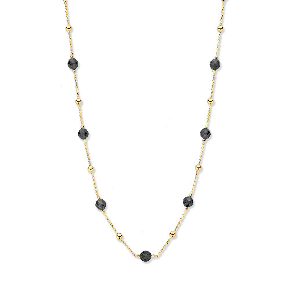 Collier van geelgoud met zwarte zirkonia's en gouden bolletjes, fijn en speels ontwerp.