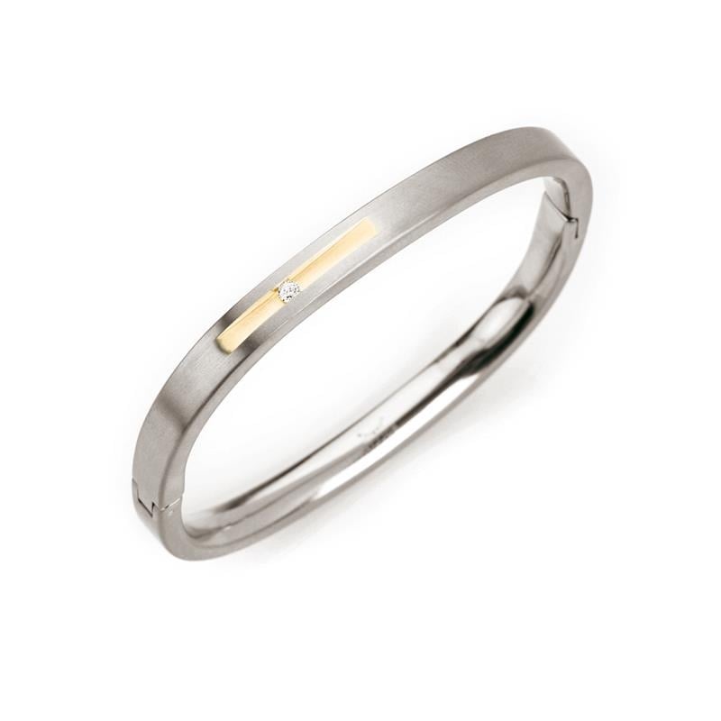 Bracciale in titanio bicolore con dettagli dorati e finitura lucida.