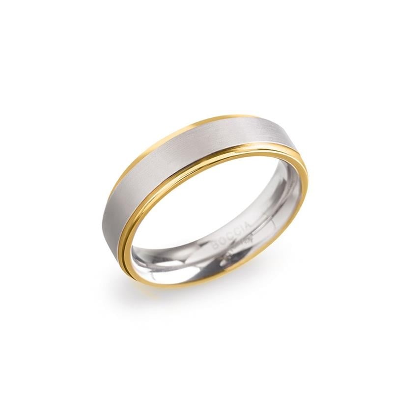 Anello in titanio bicolore con finitura lucida e dettagli dorati.