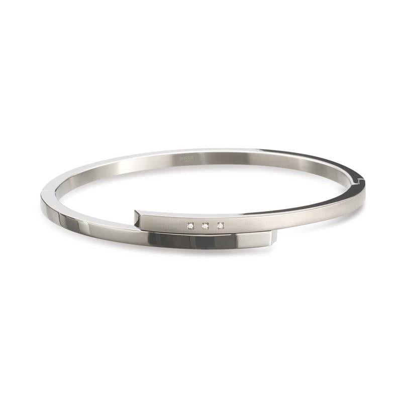 Bracciale in titanio con finitura lucida e tre piccole pietre decorative.
