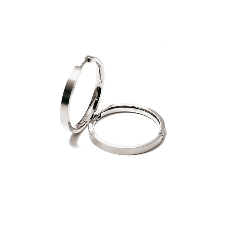 Orecchini in titanio lucido con design semplice e forma circolare.