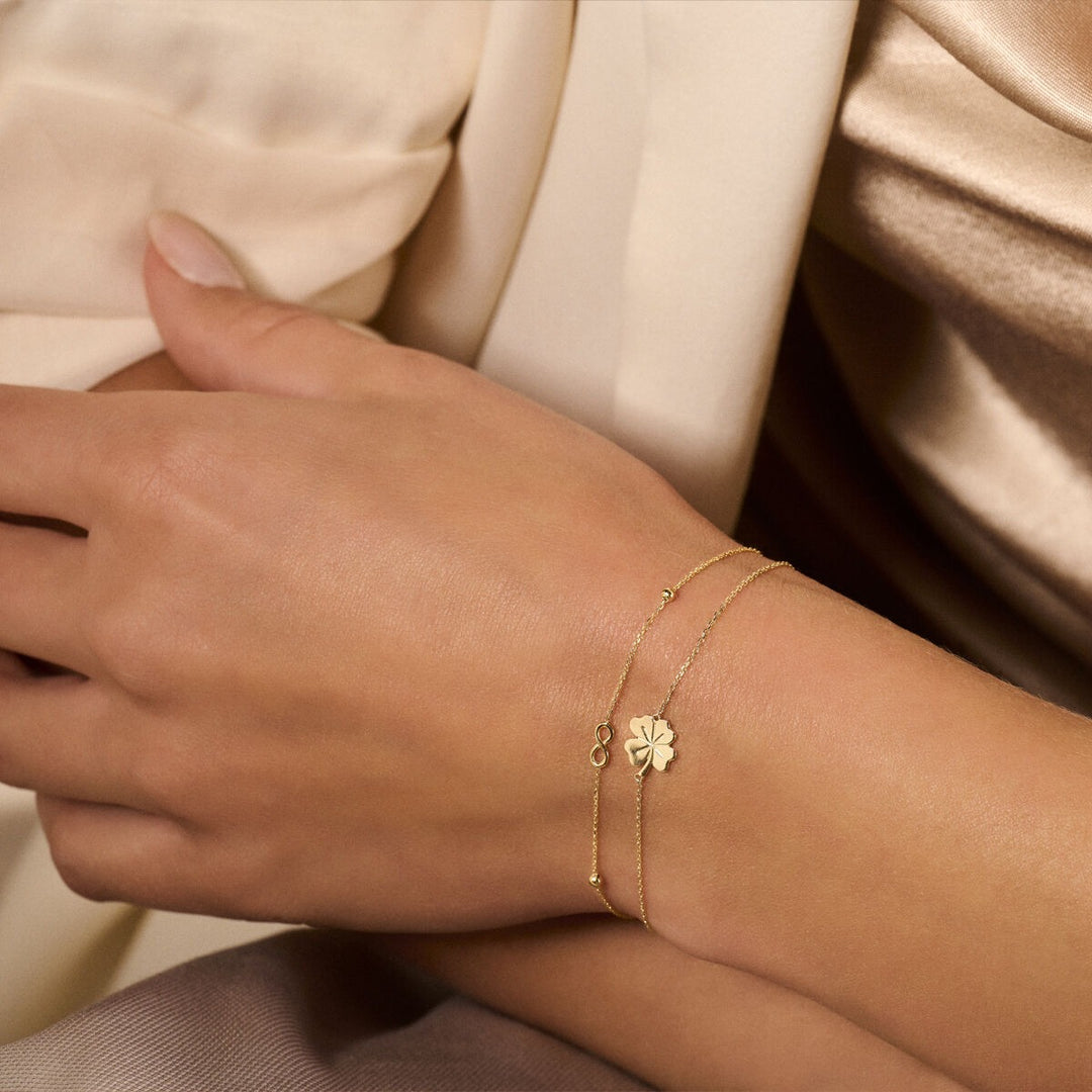9k Geelgouden dames armband met infinity symbool en bolletjes