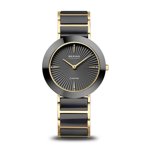 Orologio con cassa rotonda nera, quadrante grigio con dettagli dorati e cinturino in acciaio.