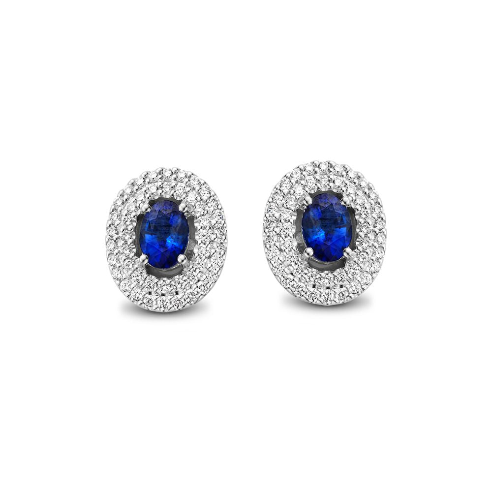 Orecchini in oro bianco con zaffiro blu e diamanti, forma ovale con incastonatura brillante.