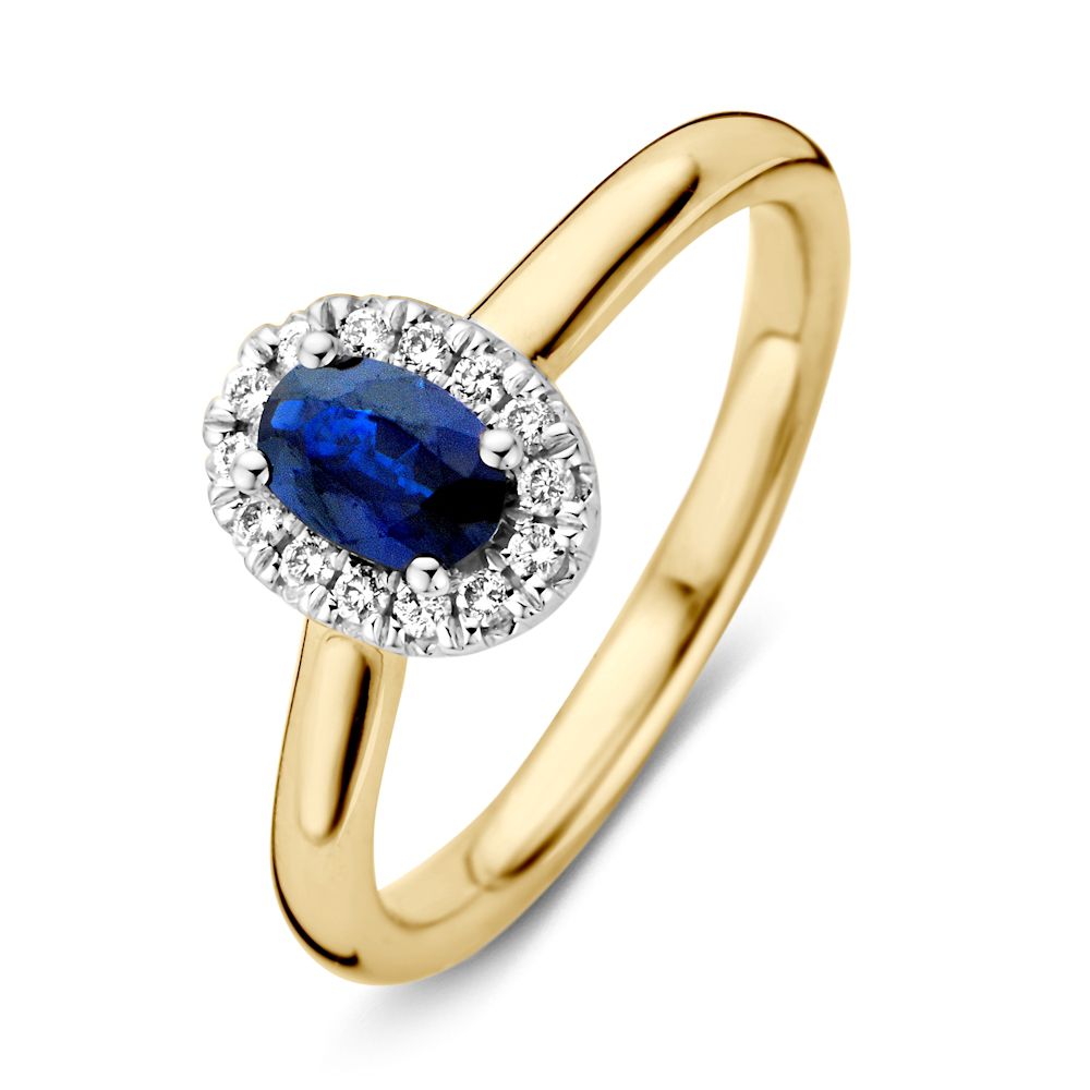 Anello da donna in oro giallo 14 carati con zaffiro blu e halo di diamanti.