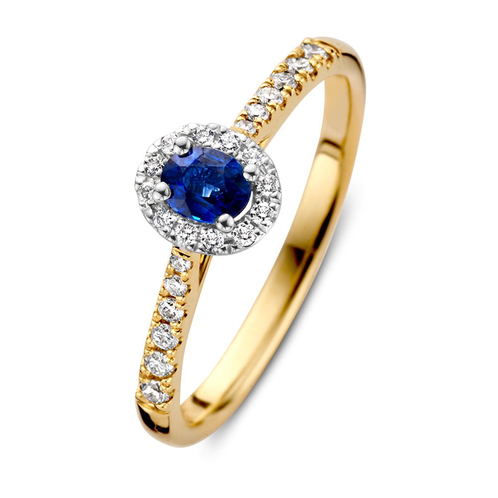 Anello in oro bicolore 14 carati con zaffiro ovale blu e halo di diamanti.