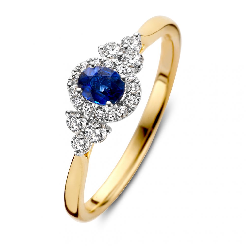 Anello da donna in oro bicolore con zaffiro blu e incastonatura vintage di diamanti.