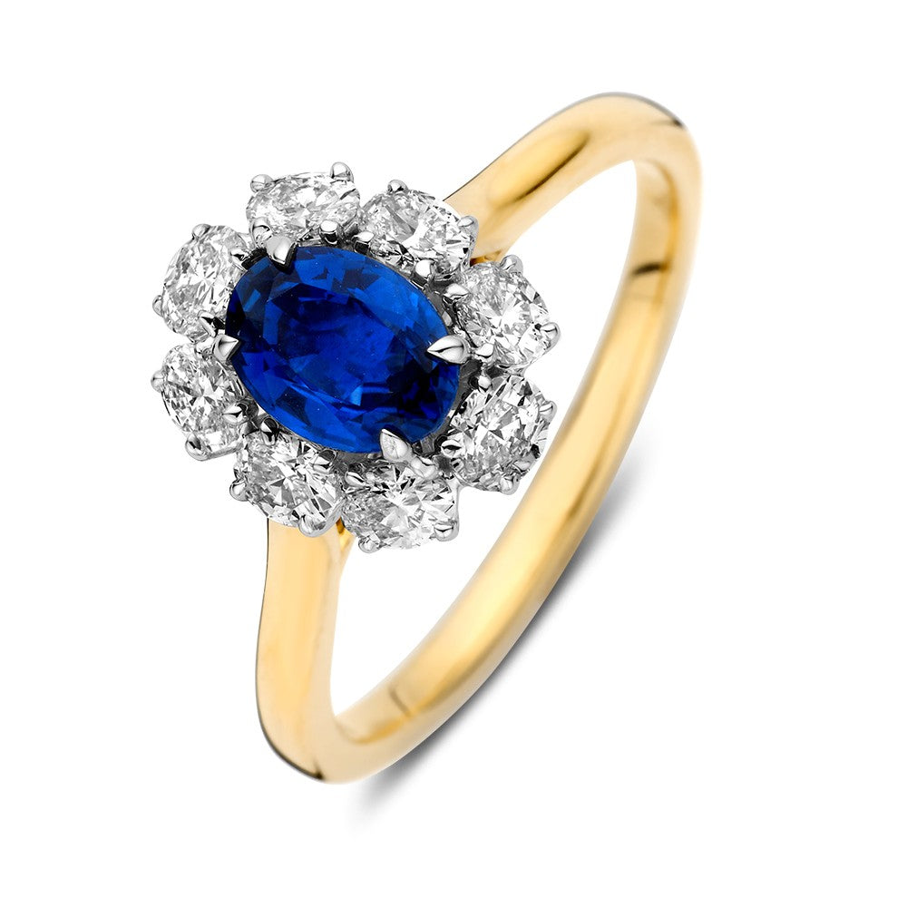 Anello bicolore con zaffiro ovale e diamanti brillanti.