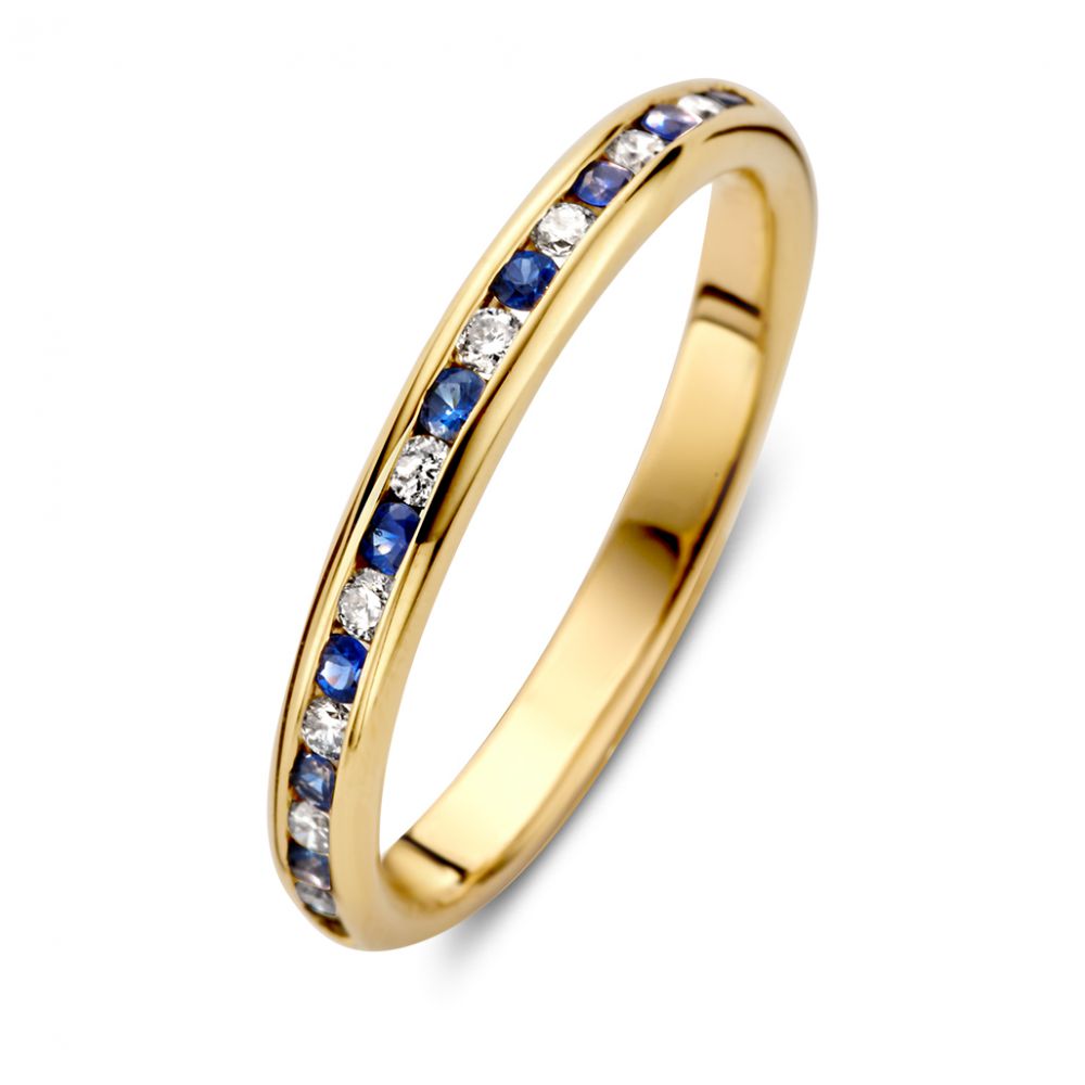 Anello in oro giallo con diamanti e zaffiri blu in incastonatura a binario.