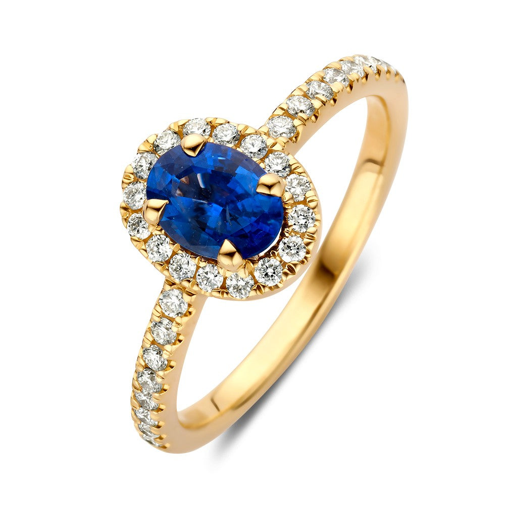 Anello in oro giallo con zaffiro ovale e diamanti incastonati.