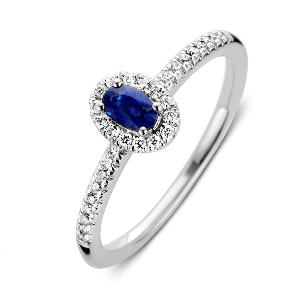 Anello in oro bianco da donna con zaffiro ovale e diamanti incastonati.
