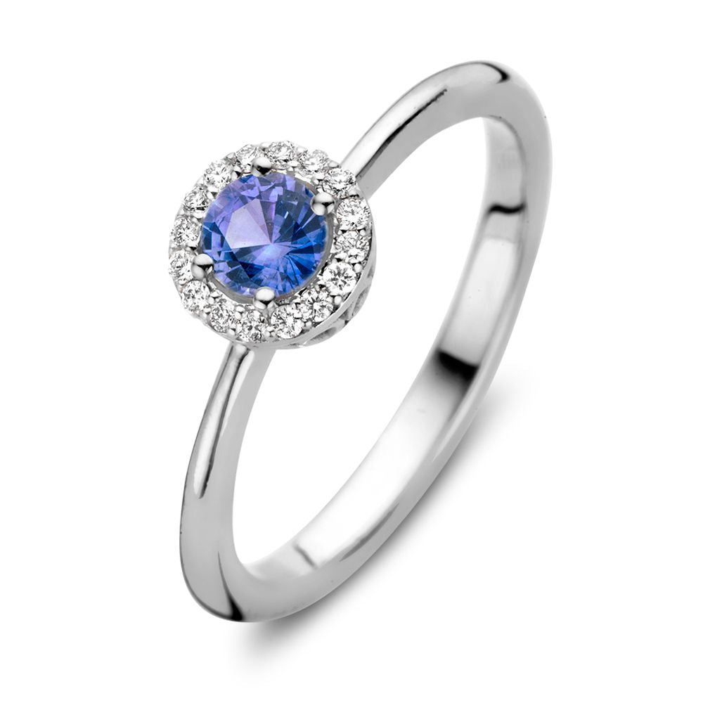 Anello in oro bianco 18kt con zaffiro blu e diamanti da 0,11ct, design con corona.