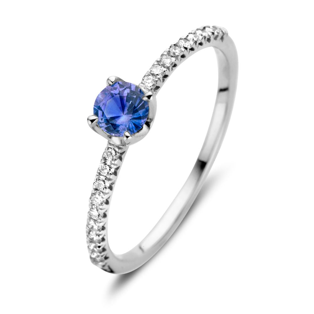 Anello in oro bianco 18kt con zaffiro blu e diamanti da 0,15 ct, design elegante.