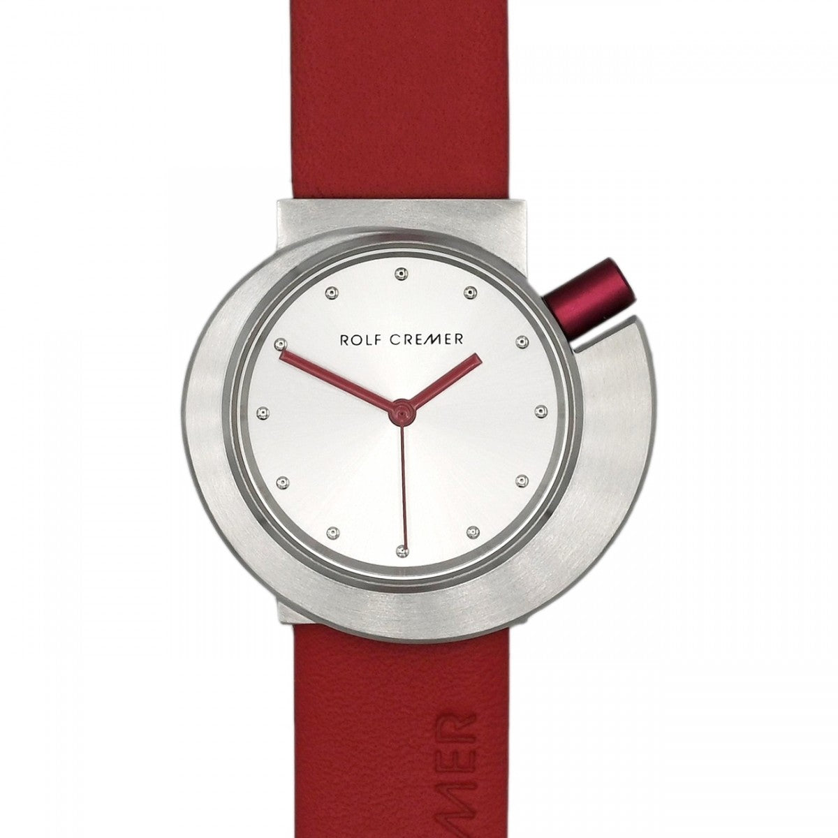 Orologio Rolf Cremer con cassa in acciaio inox, quadrante bianco e cinturino rosso.