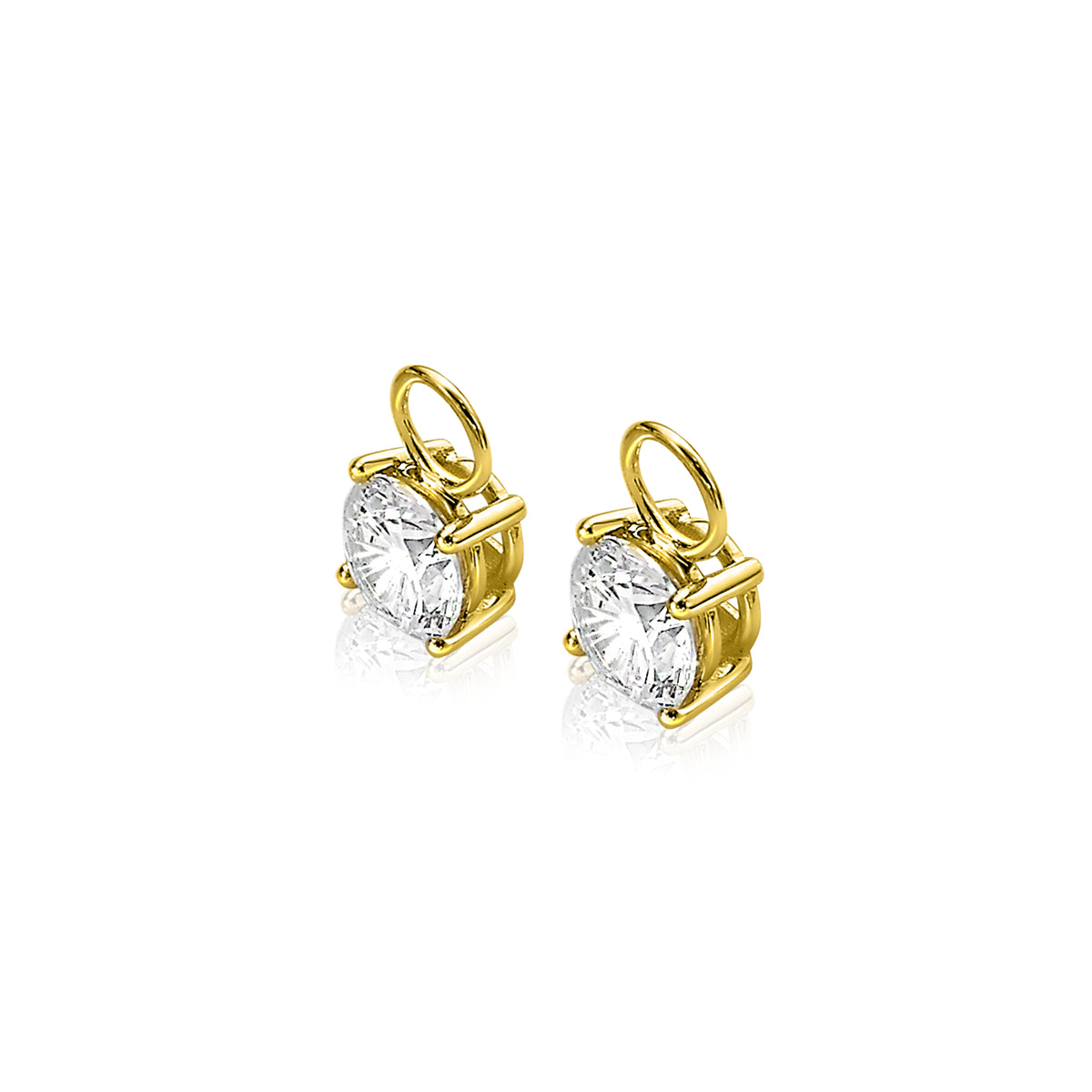 Orecchini in oro con pietre trasparenti a forma di cuore.