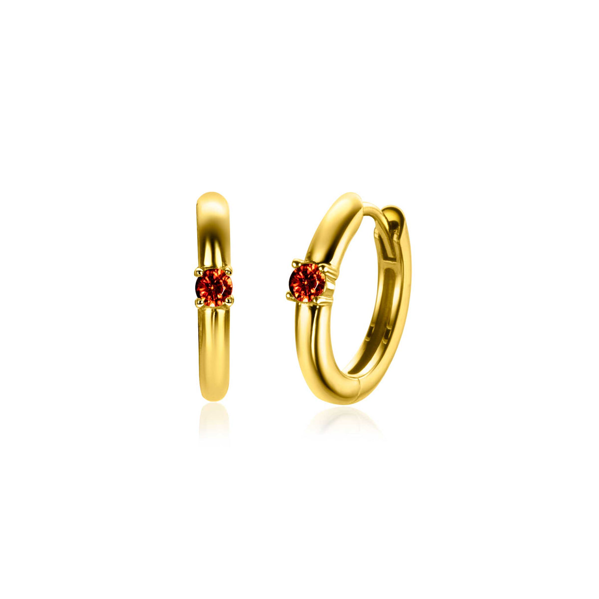 Orecchini in oro con un piccolo zircone arancione al centro.